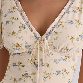 House of CB Ivory Vintage Rose floral top, close-up of V-neckline with lace trim and tie-front detail, short sleeves