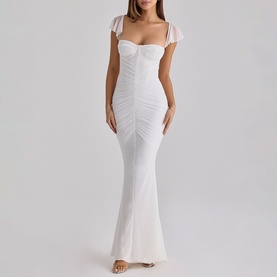 Model wearing House of CB white maxi dress with ruched bodice, sweetheart neckline, flutter cap sleeves, and fishtail hem