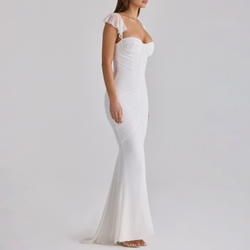 Model wearing House of CB white maxi dress with sweetheart neckline, flutter cap sleeves, and fitted mermaid silhouette