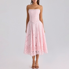 Model wearing House of CB pink strapless corset midi dress with floral lace hem, styled with strappy heeled sandals