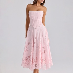 Model wearing House of CB pink strapless corset midi dress with floral cutwork embroidery on full A-line skirt