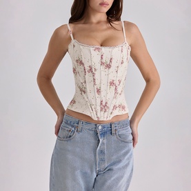 Model wearing House of CB Ivory Vintage Rose floral corset top with boning details, styled with light wash denim jeans.
