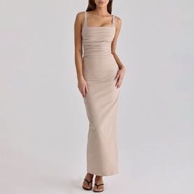 Model wearing House of CB taupe maxi dress with ruched detailing, square neckline and thin straps, styled with brown heeled sandals