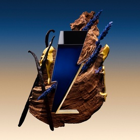 Carolina Herrera EDP in navy blue bottle with gold lightning bolt detail, styled with vanilla pods and blue crystal branches on driftwood base