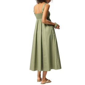 Model wearing Whistles green sleeveless midi dress with sweetheart neckline and full skirt, shown from behind, styled with tan sandals.