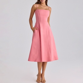 Model wearing House of CB raspberry spaghetti-strap midi dress with A-line skirt and side pockets, styled with strappy heeled sandals