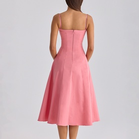 Model wearing House of CB raspberry spaghetti strap midi dress with fitted bodice and full A-line skirt, back view