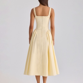Model wearing House of CB lemon midi dress with square neckline straps, structured bodice and full A-line skirt, back view