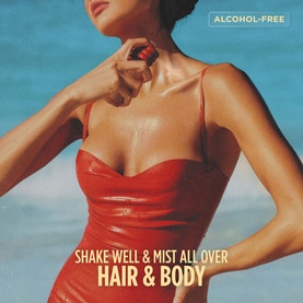 Gisou alcohol-free Hair & Body Mist lifestyle shot; model in red swimsuit at beach with text overlay: Shake Well & Mist All Over Hair & Body