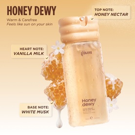 Gisou Honey Dewy Body Mist in honey-toned bottle with fragrance notes: honey nectar, vanilla milk, and white musk on warm background.
