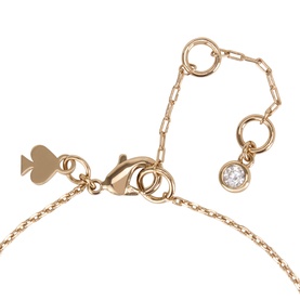 Kate Spade gold-tone plated metal necklace, close-up of lobster clasp, adjustable chain links, and single crystal charm detail