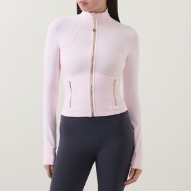 Model wearing Lululemon Pink Pearl jacket with gold zip, form-fitting silhouette, long sleeves, styled with dark grey leggings