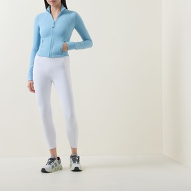 Model wearing Lululemon Seafoam zip-up jacket with white leggings and grey trainers.