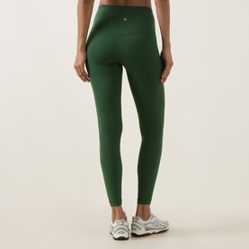 Model wearing Lululemon Ivy Grove leggings, back view, styled with white trainers