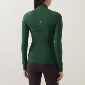 Model wearing Lululemon Jacket in Ivy Grove, rear view, fitted silhouette with mock neck, long sleeves and seam detailing.