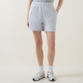 Model wearing Lululemon shorts in Heathered Core Ultra Light Grey, styled with white ankle socks and chunky trainers.