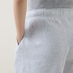 Model wearing Lululemon shorts in Heathered Core Ultra Light Grey, close-up of back pocket and elasticated waistband detail