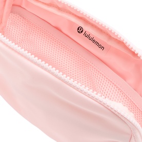 Lululemon Pink Pearl pouch interior showing mesh pocket, zip closure, and branded logo lining in soft pink fabric.
