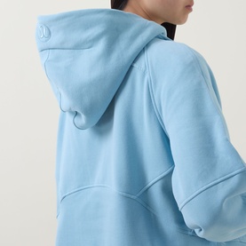 Model wearing Lululemon seafoam hoodie, rear view showing hood detail and panelled hem construction