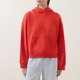 Model wearing Lululemon Cherry Ember hoodie sweatshirt with kangaroo pocket, styled with light grey joggers