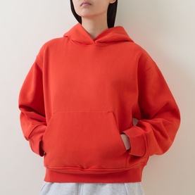 Model wearing Lululemon Cherry Ember oversized pullover hoodie with kangaroo pocket, styled with light grey joggers.
