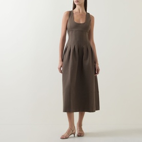 Model wearing Odd Muse Cinched Pleated Dress in Mushroom, scoop neck, boned bodice, pleated midi skirt, styled with nude heeled mules.