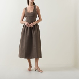 Model wearing Odd Muse Cinched Pleated Dress in Mushroom, featuring scoop neckline, boned bodice and pleated midi skirt, styled with nude heels.