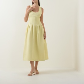 Model wearing Odd Muse Cinched Pleated Dress in lemon, scoop neck, boned bodice, pleated midi skirt, styled with nude heeled mules.