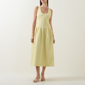 Model wearing Odd Muse Cinched Pleated Dress in lemon, featuring scoop neckline, boned bodice and pleated midi skirt, styled with nude sandals.