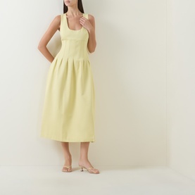 Model wearing Odd Muse Cinched Pleated Dress in lemon, with scoop neckline, boned bodice, and pleated midi skirt, styled with nude heels.