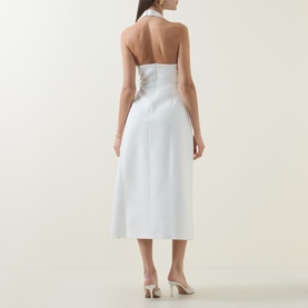 Model wearing Odd Muse Cinched Halter Dress in white, showing open halter back, cinched waist, and midi-length skirt. Styled with nude heels.