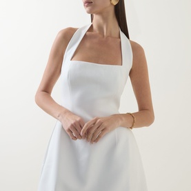Model wearing Odd Muse Cinched Halter Dress in white, featuring structured halter neckline and cinched waist, styled with gold jewellery