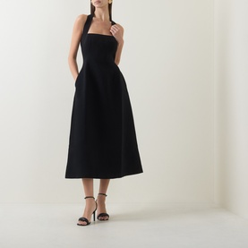 Model wearing Odd Muse Cinched Halter Dress in black, featuring structured bodice, cinched waist and midi-length skirt, styled with black strappy