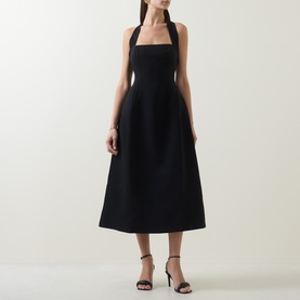 Model wearing Odd Muse Cinched Halter Dress in black, featuring structured bodice, cinched waist and full midi skirt, styled with black heeled