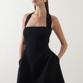 Model wearing Odd Muse Cinched Halter Dress in black with square neckline, structured bodice, cinched waist and side pockets