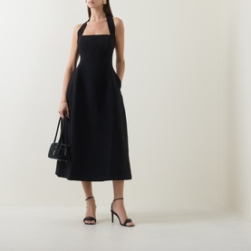 Model wearing Odd Muse Cinched Halter Dress in black, midi length with structured bodice. Styled with black strappy heels and small black bag.
