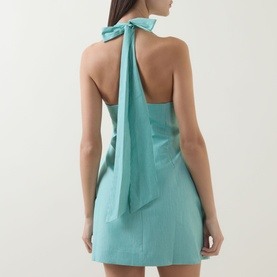 Model wearing Odd Muse Pinstripe Tie-Neck Mini Dress in Green Pinstripe, showing open back with long halter neck tie and mini length.