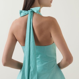 Model wearing Odd Muse Pinstripe Tie-Neck Mini Dress in Green Pinstripe, showing open back with halter tie-neck detail.