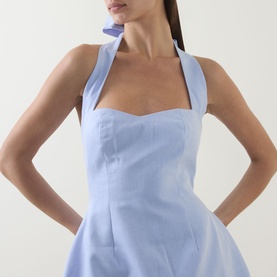 Model wearing Odd Muse Pinstripe Tie-Neck Mini Dress in Blue Pinstripe, showing sweetheart neckline, structured bodice and halter tie detail.