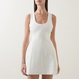 Model wearing Odd Muse Volume Mini Dress in ecru with scoop neckline, sleeveless fit, cinched waist and structured flared mini skirt.