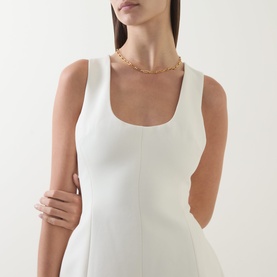Model wearing Odd Muse Volume Mini Dress in ecru, scoop neckline, sleeveless, styled with a gold chain necklace.