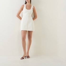 Model wearing Odd Muse Volume Mini Dress in ecru with scoop neckline, sleeveless silhouette and structured volume skirt, styled with strappy heeled