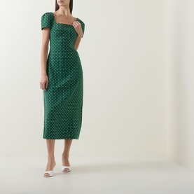 Model wearing Odd Muse Polka Dot Slip Dress in Green Polka Dot; square neckline, short puff sleeves, midi length, styled with white mule heels.