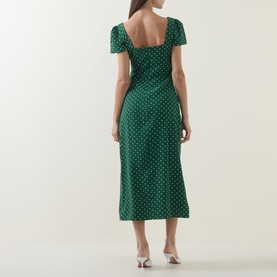 Model wearing Odd Muse Polka Dot Slip Dress in green polka dot, midi length, short sleeves, back zip, styled with white heeled mules.