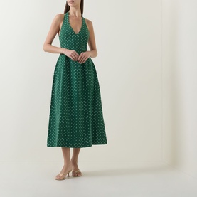 Model wearing Odd Muse Volume Polka Dot Tie-Neck Dress in green polka dot, midi length with cinched waist and flared skirt, styled with nude heeled