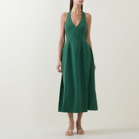 Model wearing Odd Muse Volume Polka Dot Tie-Neck Dress in green polka dot, V-neck, sleeveless, cinched waist, flared midi skirt, styled with strappy