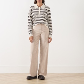 Model wearing Part Two Mole Stripe knit polo jumper with wide-leg stone trousers and black loafers
