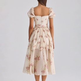 Model wearing House of CB Ivory Vintage Rose floral midi dress with puff sleeves, square neckline, and full A-line skirt, back view.