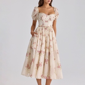 Model wearing House of CB Ivory Vintage Rose floral midi dress with puff sleeves, sweetheart neckline, and tiered full skirt