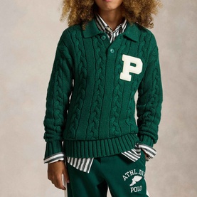Model wearing Ralph Lauren Letter Logo Cable Knitted Sweater in green with chenille P patch, styled with striped shirt and matching joggers.